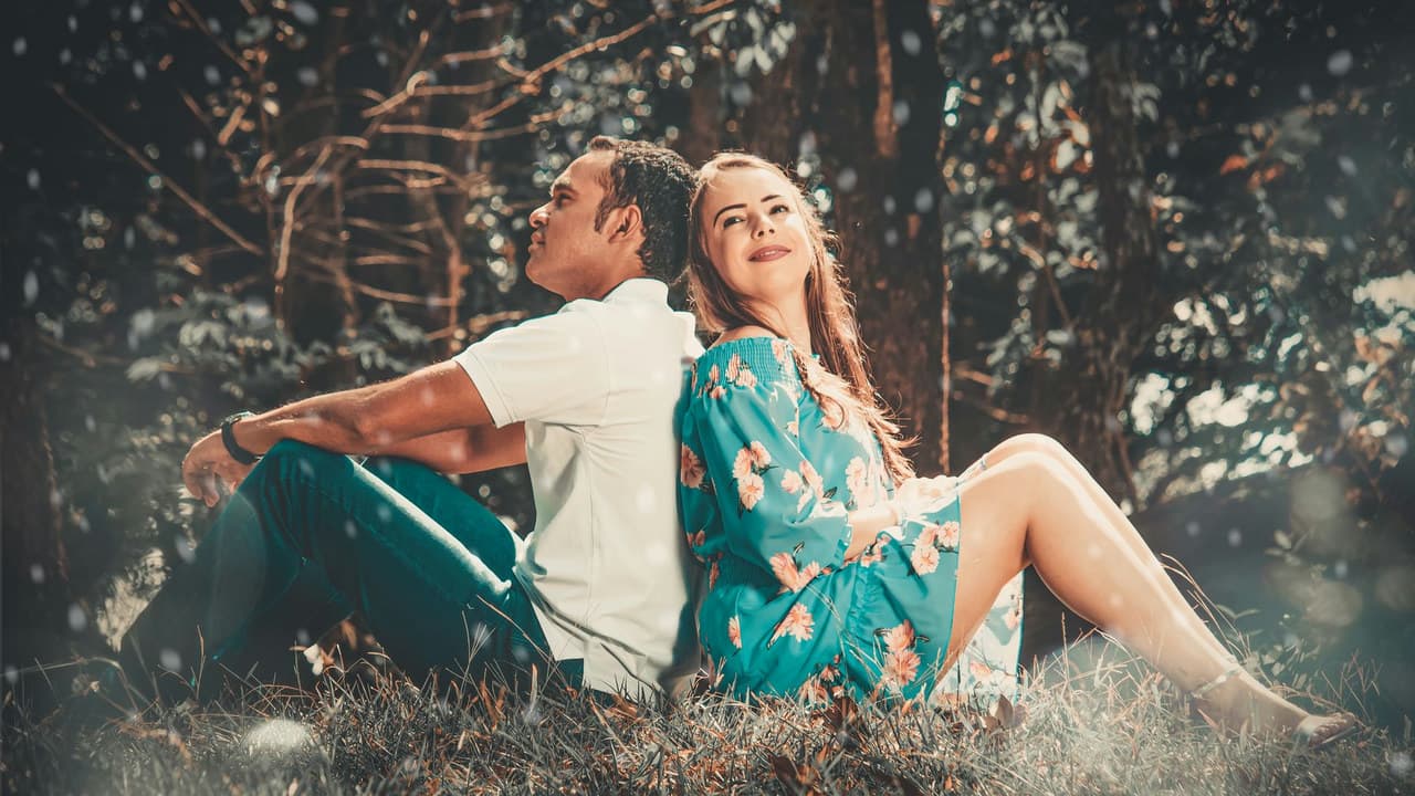 A couple enjoys a serene moment together in a lush park, evoking feelings of love and happiness.