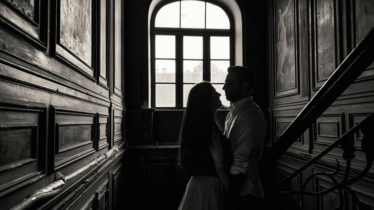 A romantic couple stands in silhouette against a classic wooden interior, suggesting timeless love.